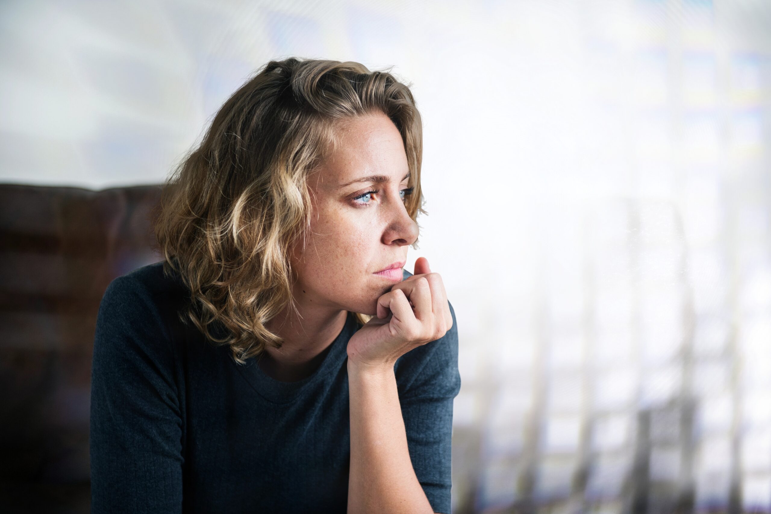 Stress woman sitting thoughtfully alone
